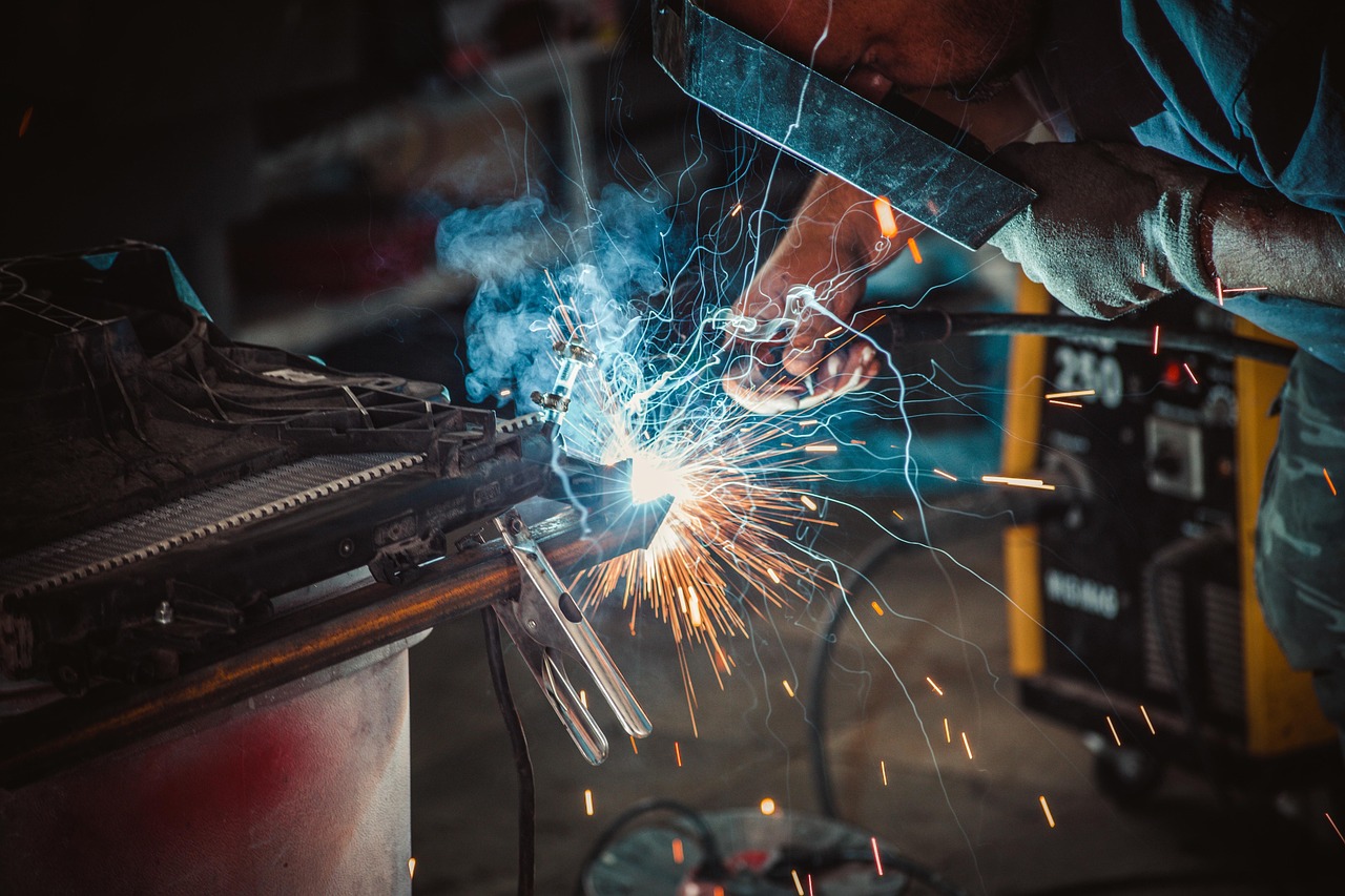 A person welding metal in a workshop, representing the skilled everyday work that helps create long-term value.