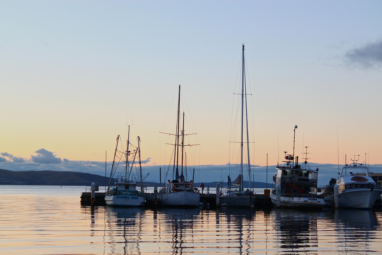 Boats safely moored in calm water, representing an investment approach that balances short-term security with long-term growth