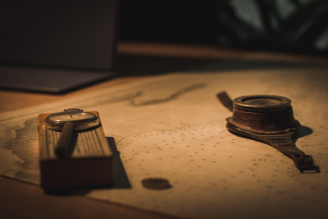 A compass and navigation chart on a table, representing a financial planning process that helps people understand where they are, where they want to go, and how to stay on track