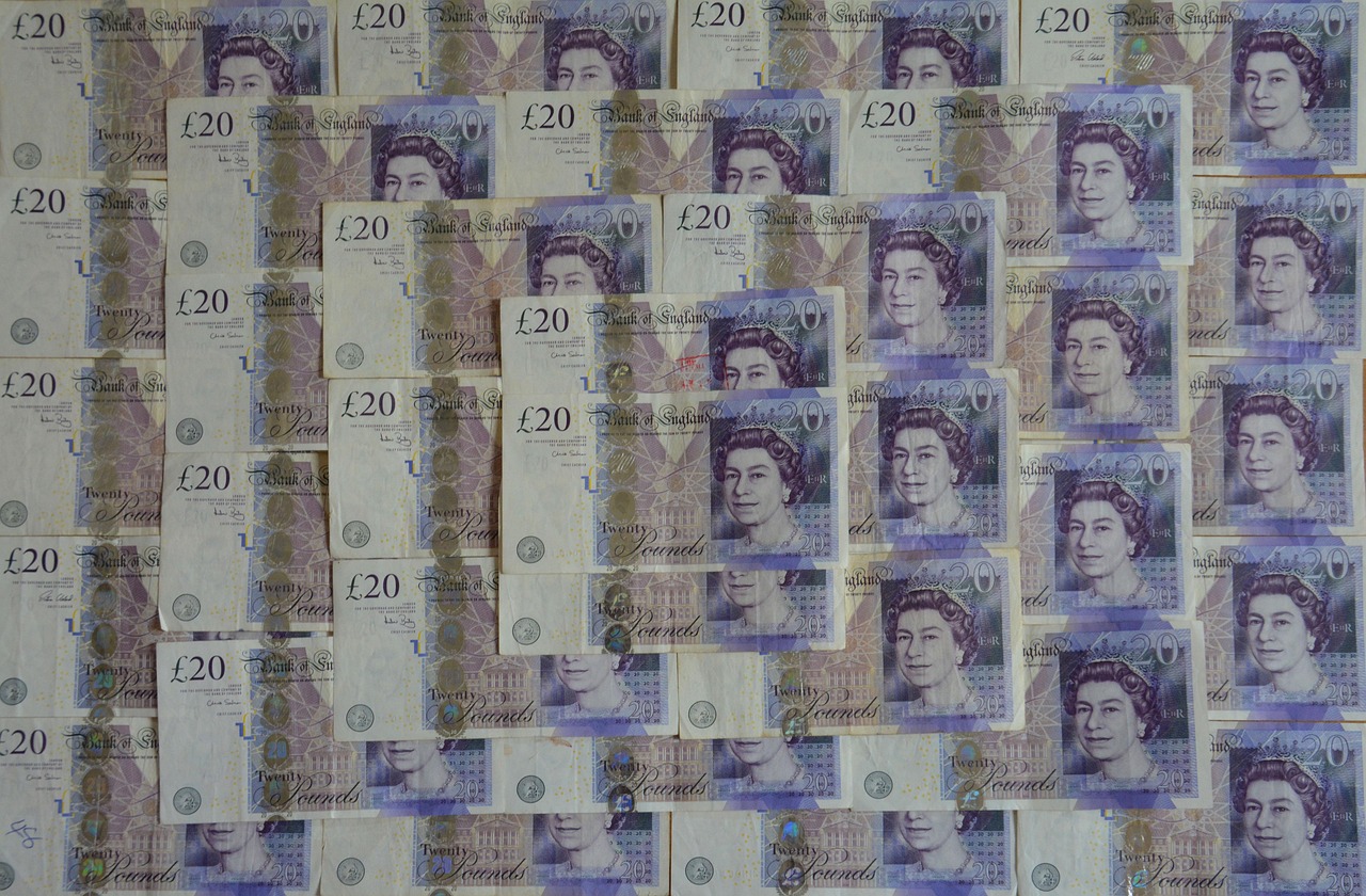 A collection of overlapping £20 Bank of England notes arranged in rows.