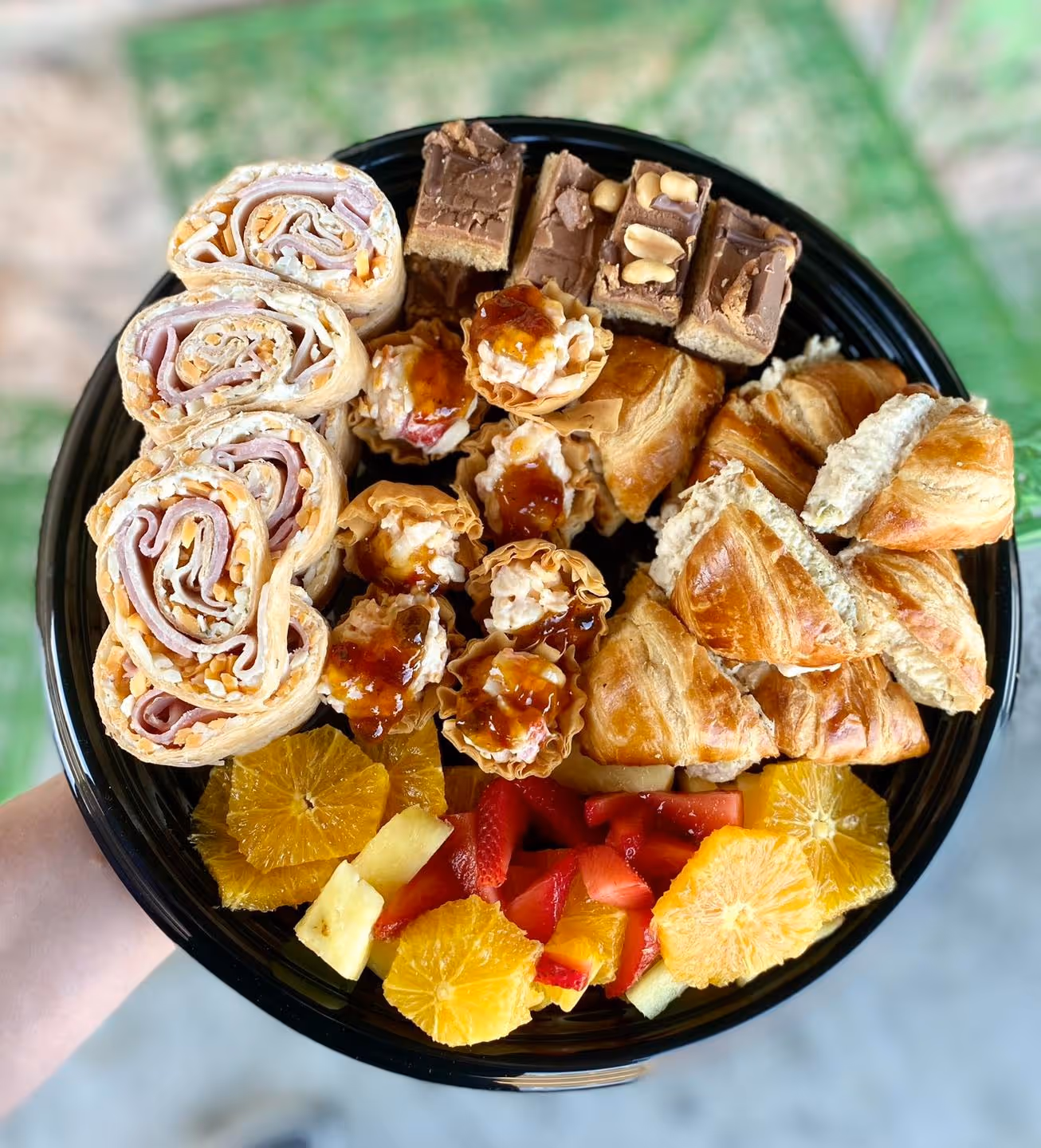 Chicken salad crossaints, ham and American cheese wrapp, sweet chicken thumblings, orange, strawberries and pear cubes