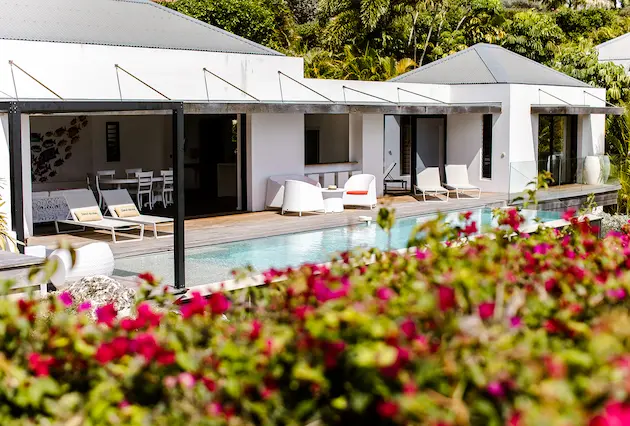 Villa de luxe à La Toubana Hôtel & Spa, salon ouvert sur terrasse avec piscine et vue mer en Guadeloupe.
