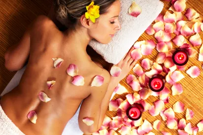 Woman receiving a relaxing rose petal massage in a luxury villa in Mauritius.