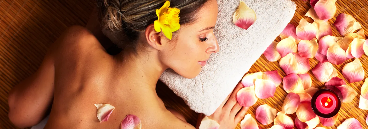Woman receiving a relaxing rose petal massage in a luxury villa in Mauritius.