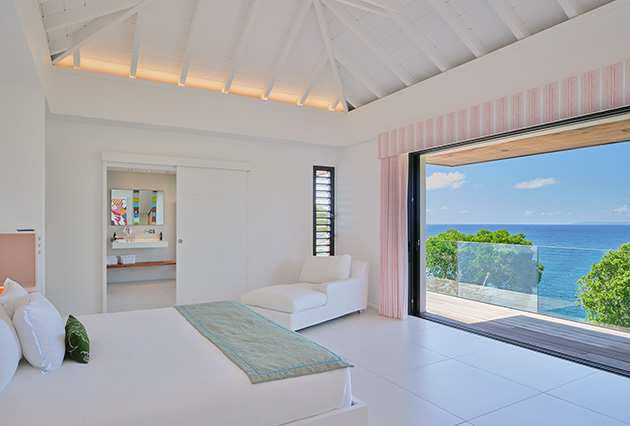 Ayati villa bed at La Toubana Hotel & Spa, room overlooking the pool in Guadeloupe.
