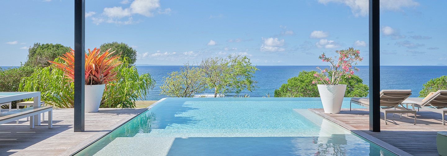 Turquoise pool with sun loungers at La Toubana Hotel & Spa, a 5-star hotel in the Caribbean.