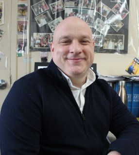 Cornelius Griffin smiling in a classroom setting