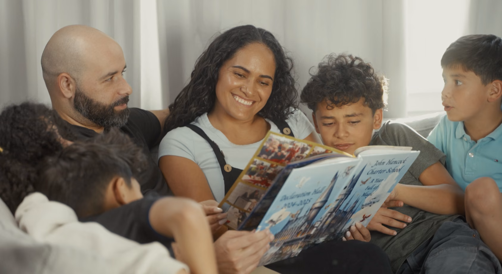 Family reading a yearbook together