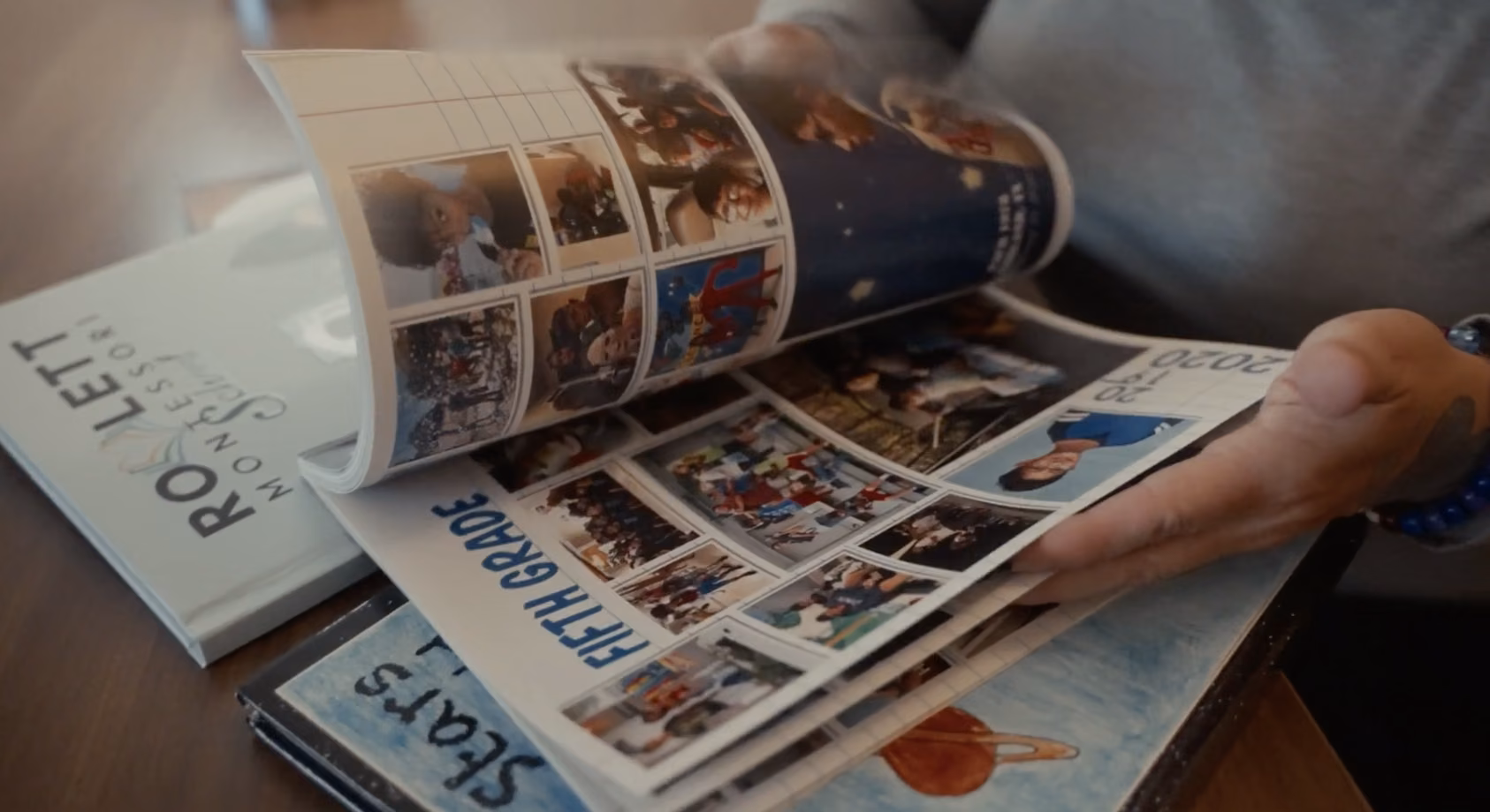 Hands flipping through printed yearbooks