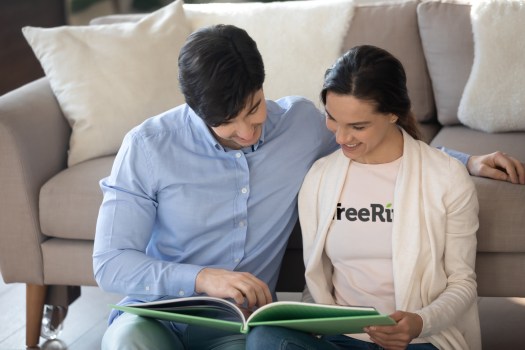 Couple reminiscing over their middle school yearbook tradition