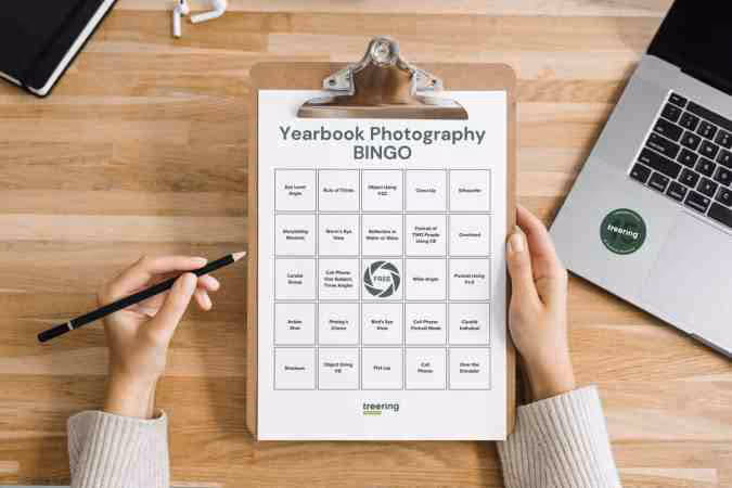 Yearbook Photography Bingo sheet displayed on a clipboard. Each space features a different type of photo to capture.