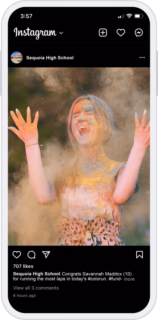 Girl joyfully throwing colored powder in the air during a color run event.