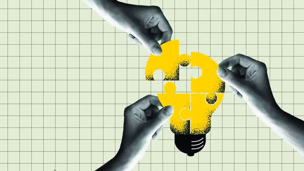 Three hands placing yellow puzzle pieces that form a lightbulb shape on a grid background.