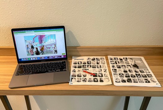 Computer with yearbook layout and PDF proof next to it