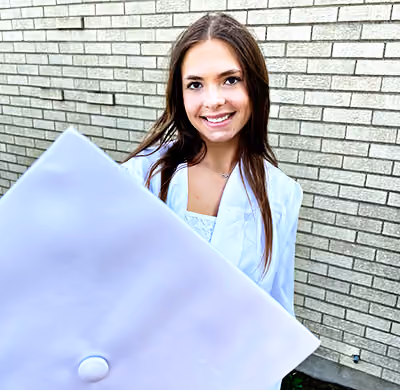 Graduate holding her cap in front to create depth