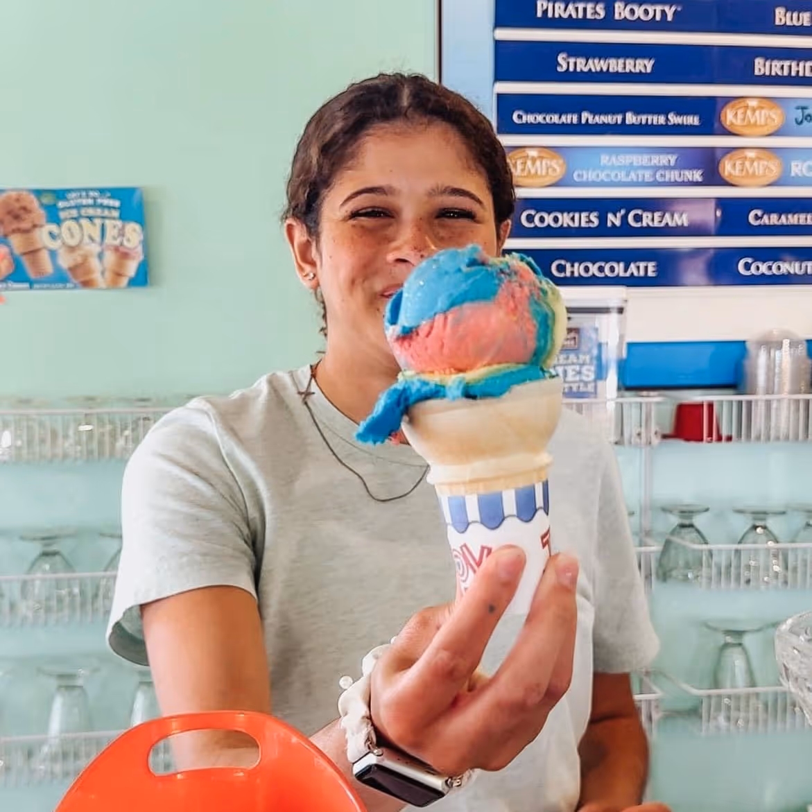 A woman showing an ice cream cone.