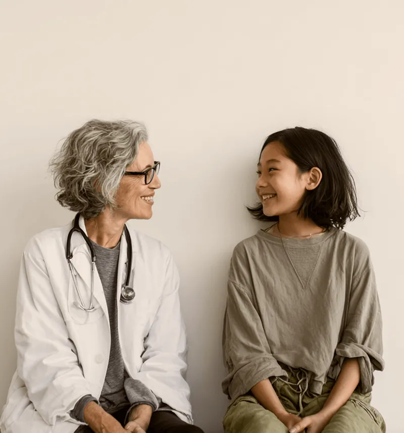 Doctor talking to asian child