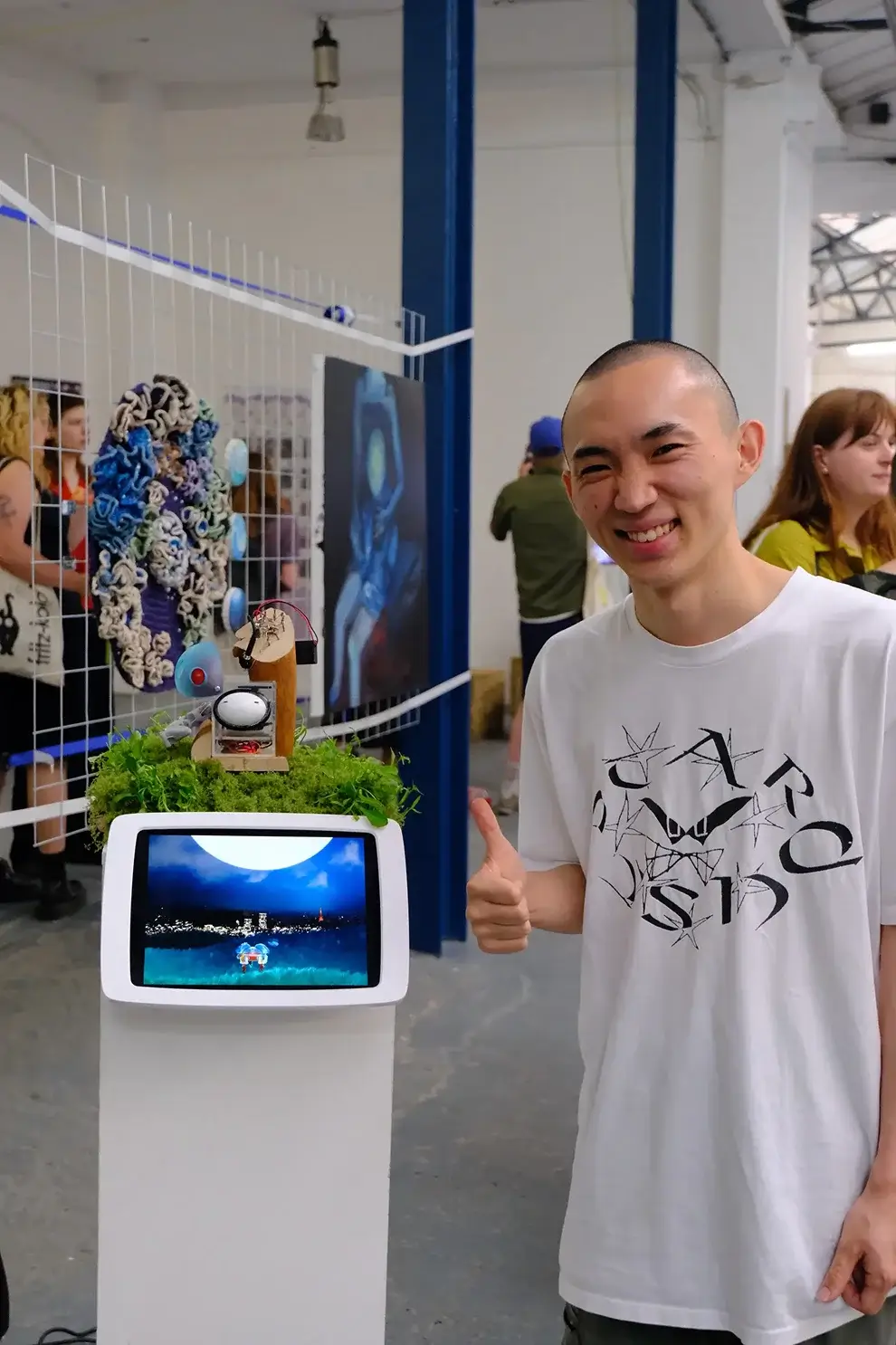 Person standing next to Alice Robot