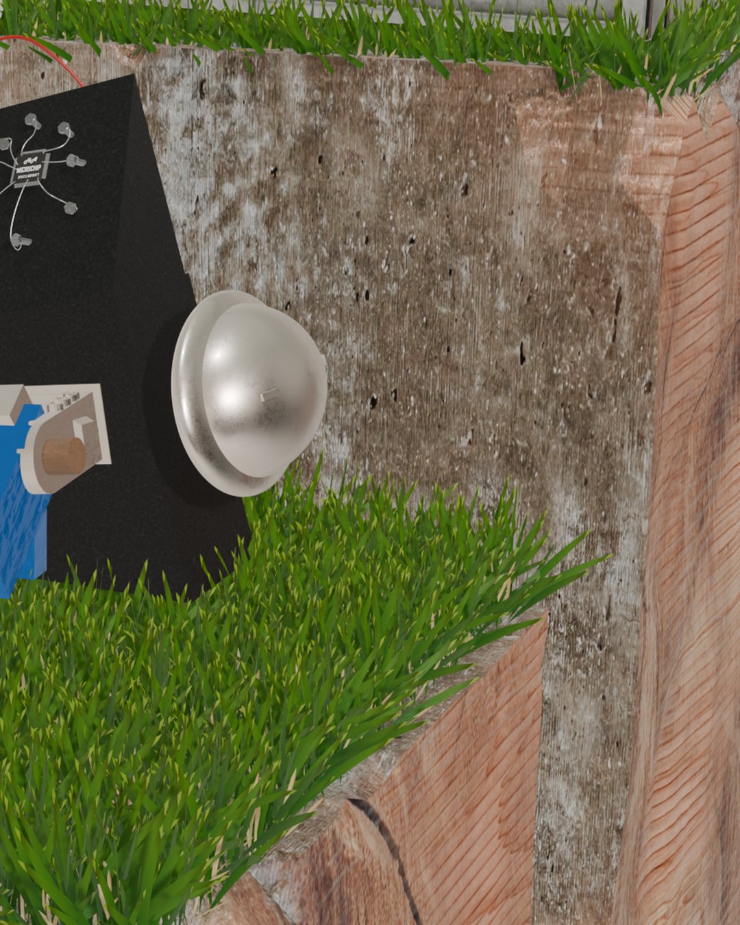 Device with a metal dome mounted on a grass-topped wooden plinth