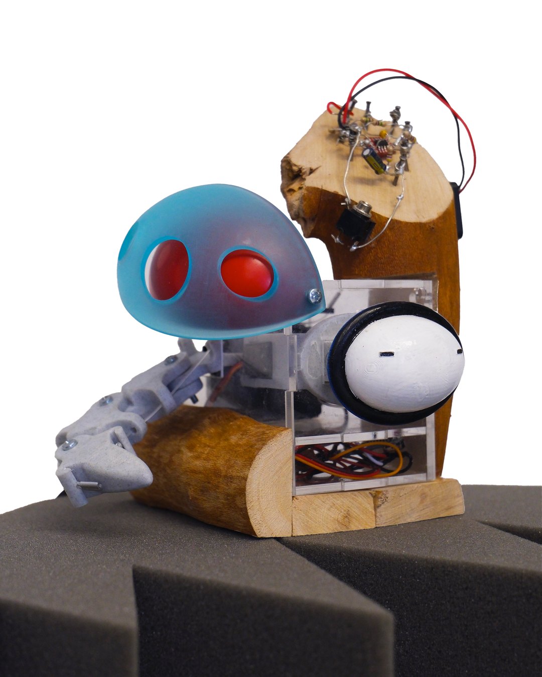 Robot with a blue dome head and red eyes on a wooden stand