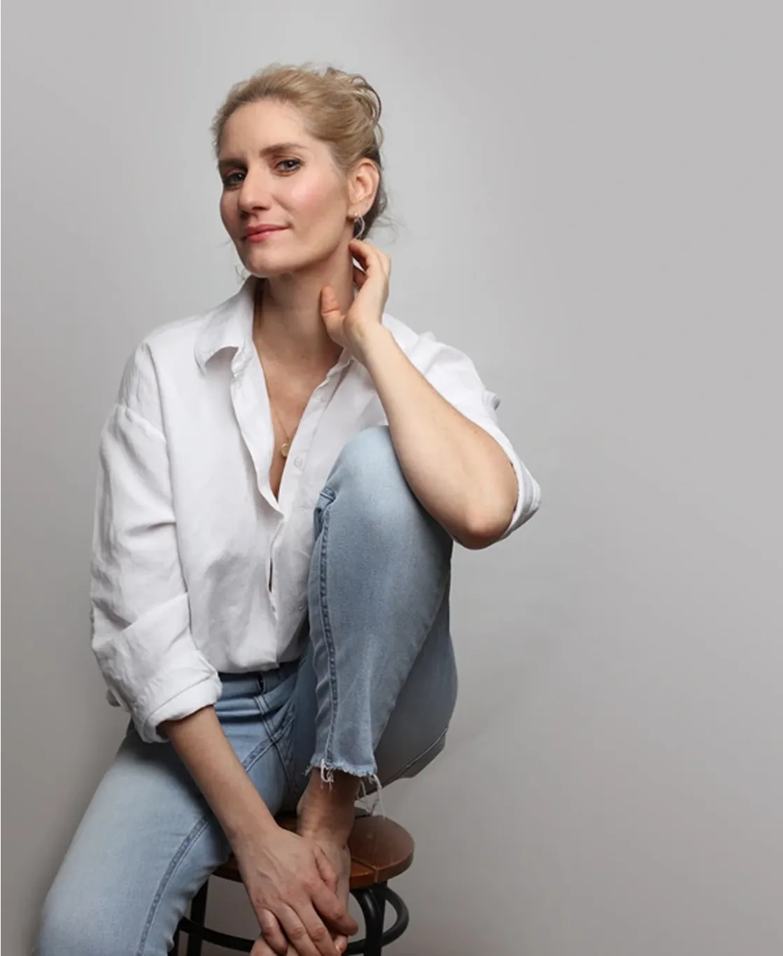 Lucia sedí na stoličke.