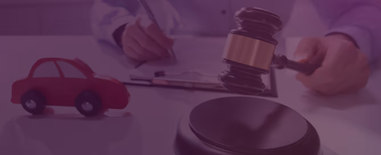 Judge holding a gavel above its base with a red toy car and a person writing on a clipboard in the background.