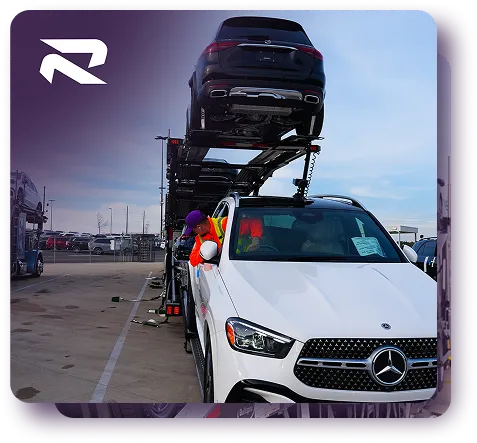 Rivalane auto transport carrier loaded with vehicles including a white sedan