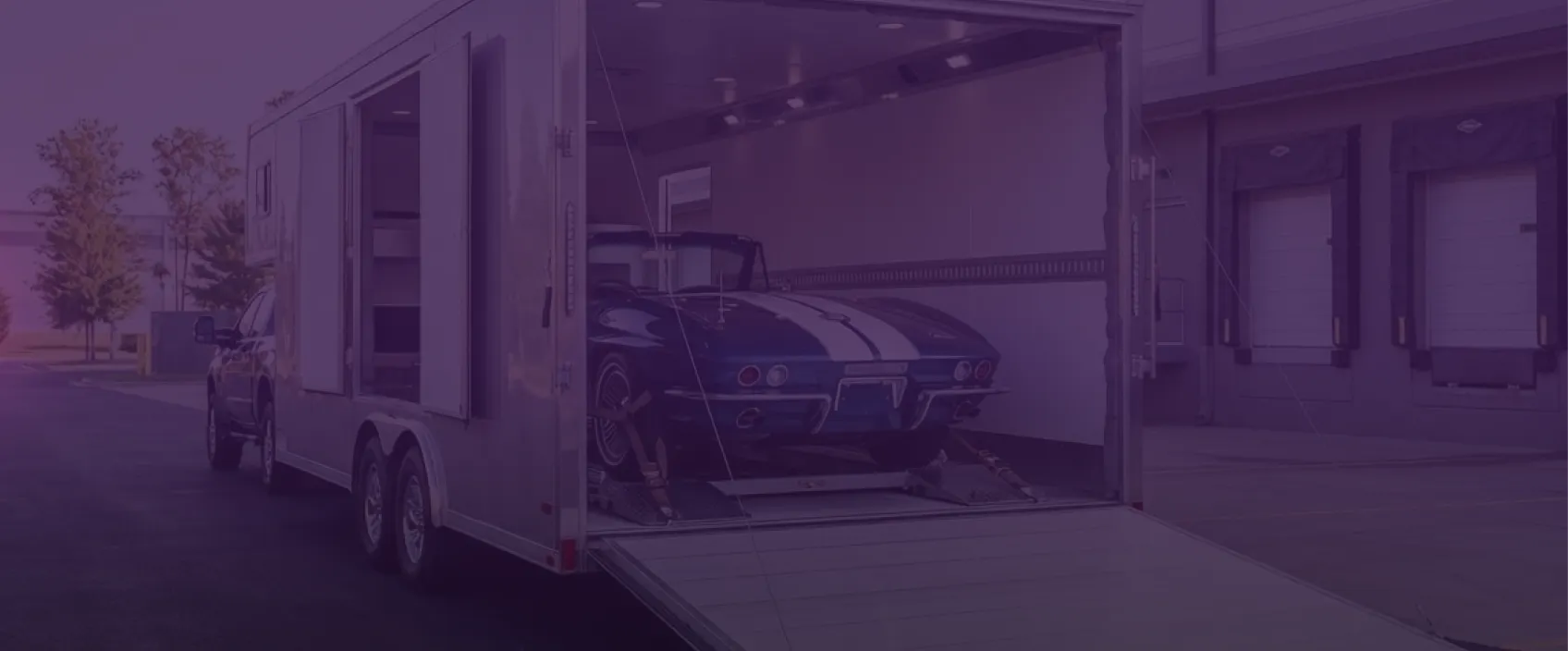 Car secured inside an enclosed transport trailer, ready for shipping