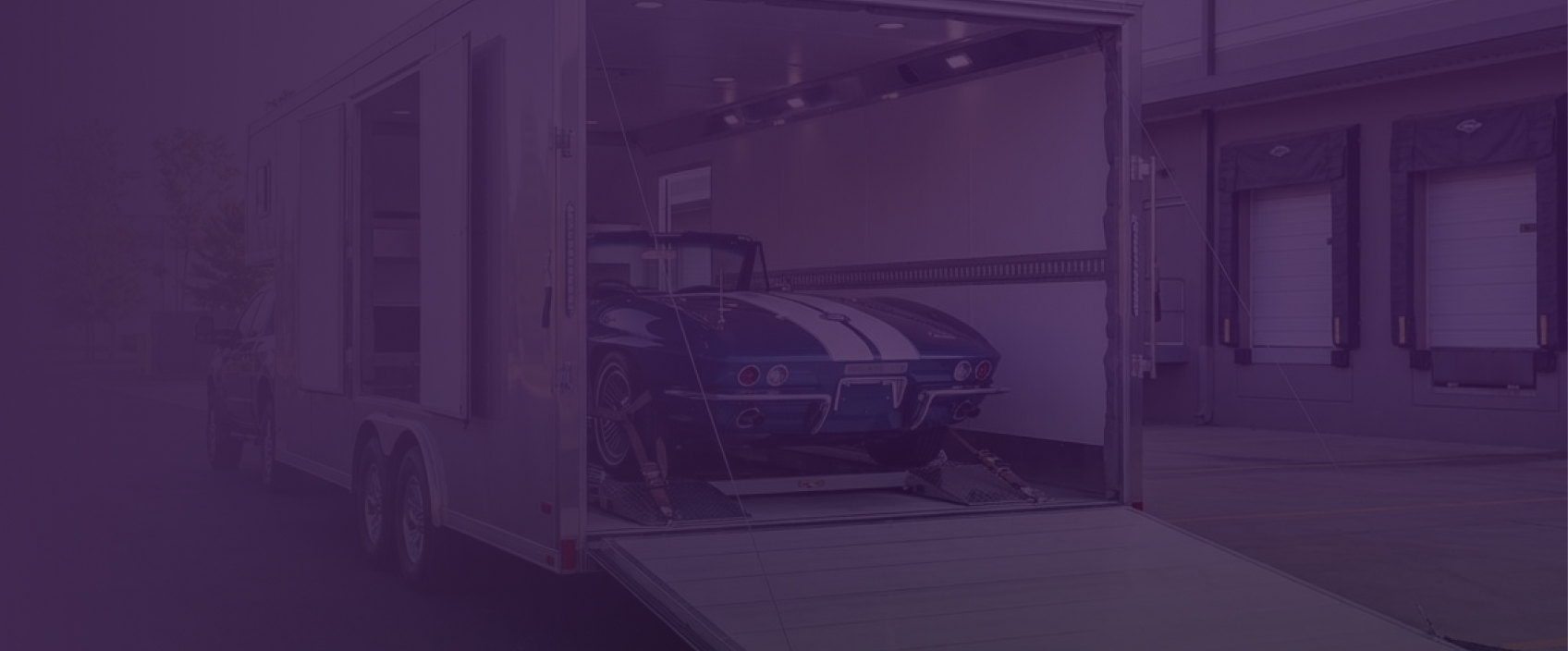 Car secured inside an enclosed transport trailer, ready for shipping