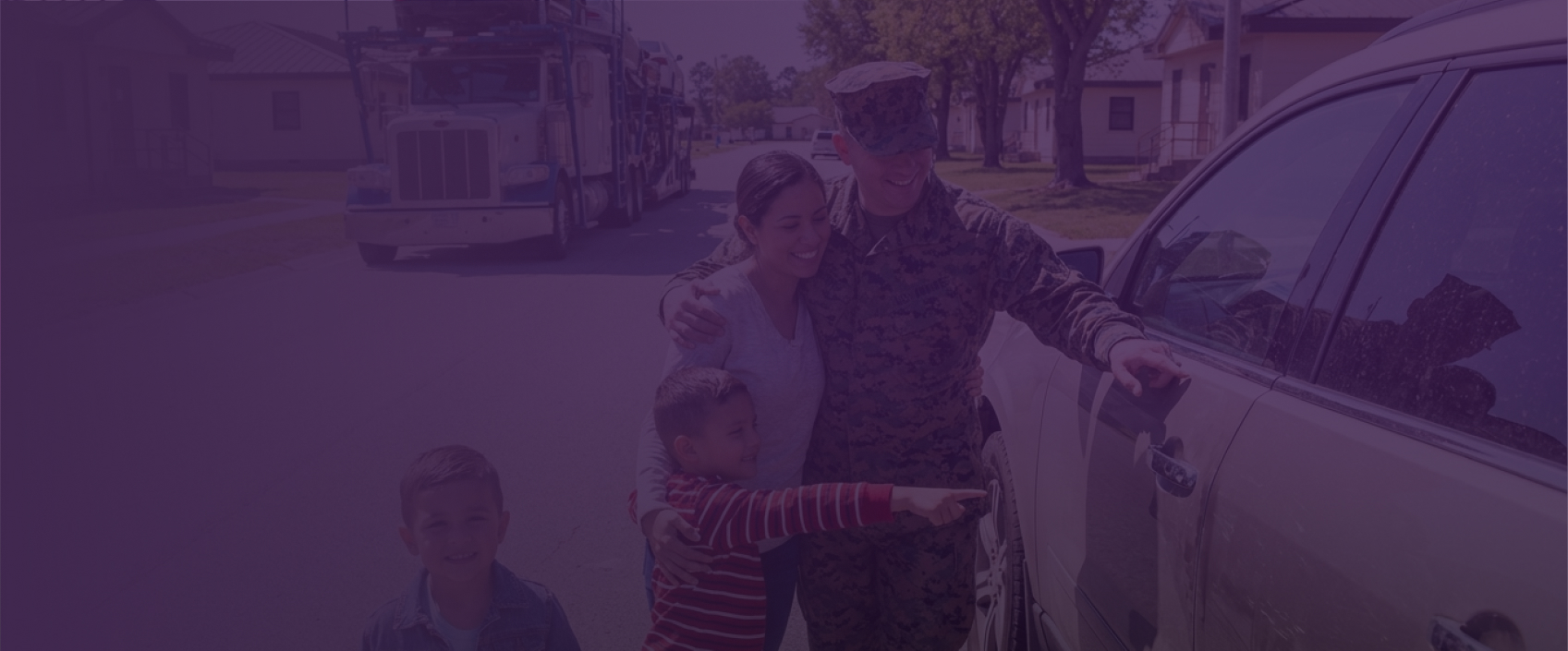 Service member reunited with their family beside a car, representing a military relocation.