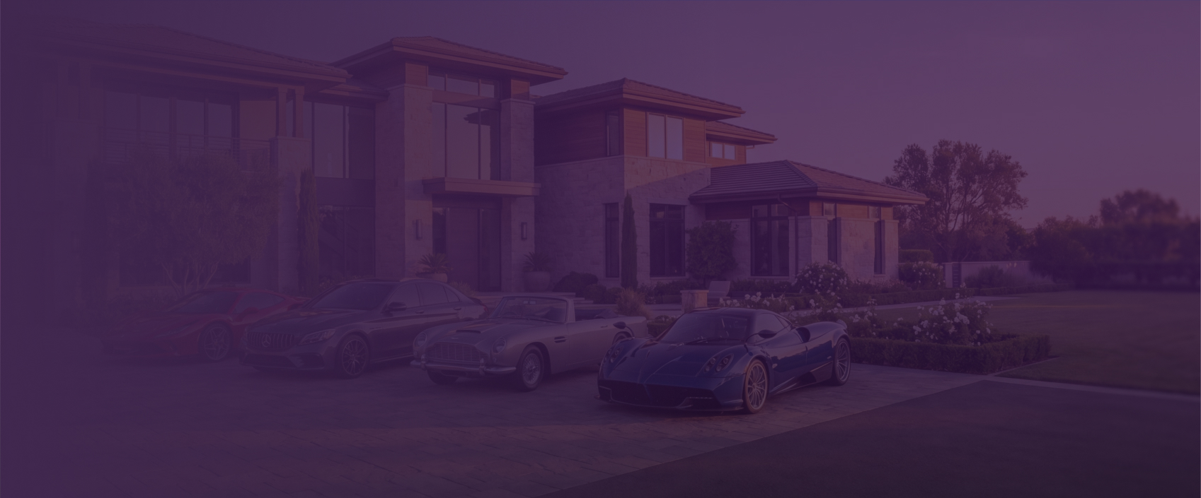 	Classic and exotic sports cars parked in front of a large modern home at sunset.