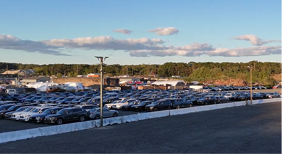 Cars parked in rows at Rivalane's outdoor vehicle storage yard in Kings Park, New York