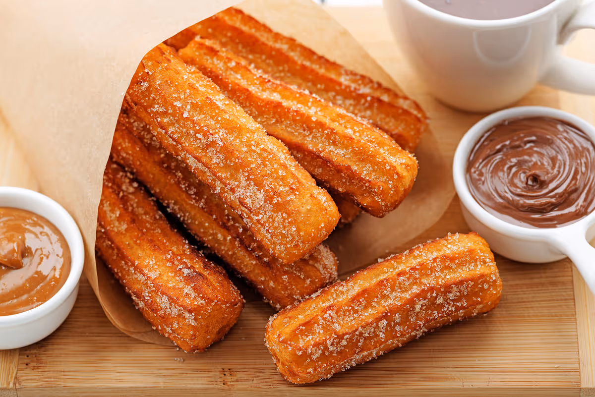 churros with chocolate and dulce de leche on the side