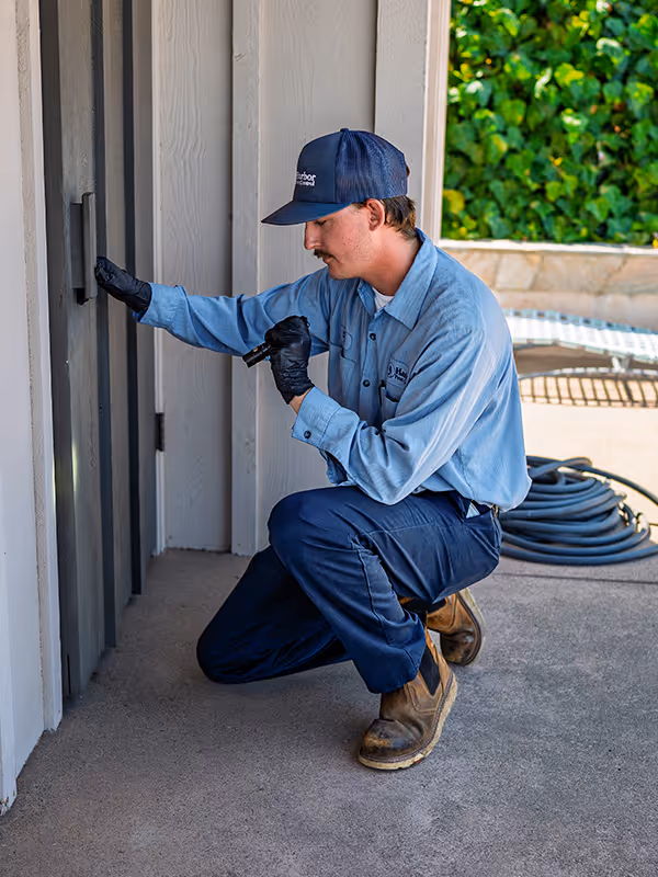 pest pro inspecting outside of home