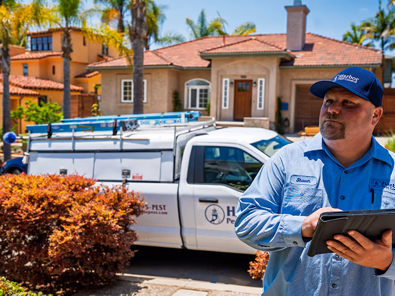 pest technician holding a clipboard