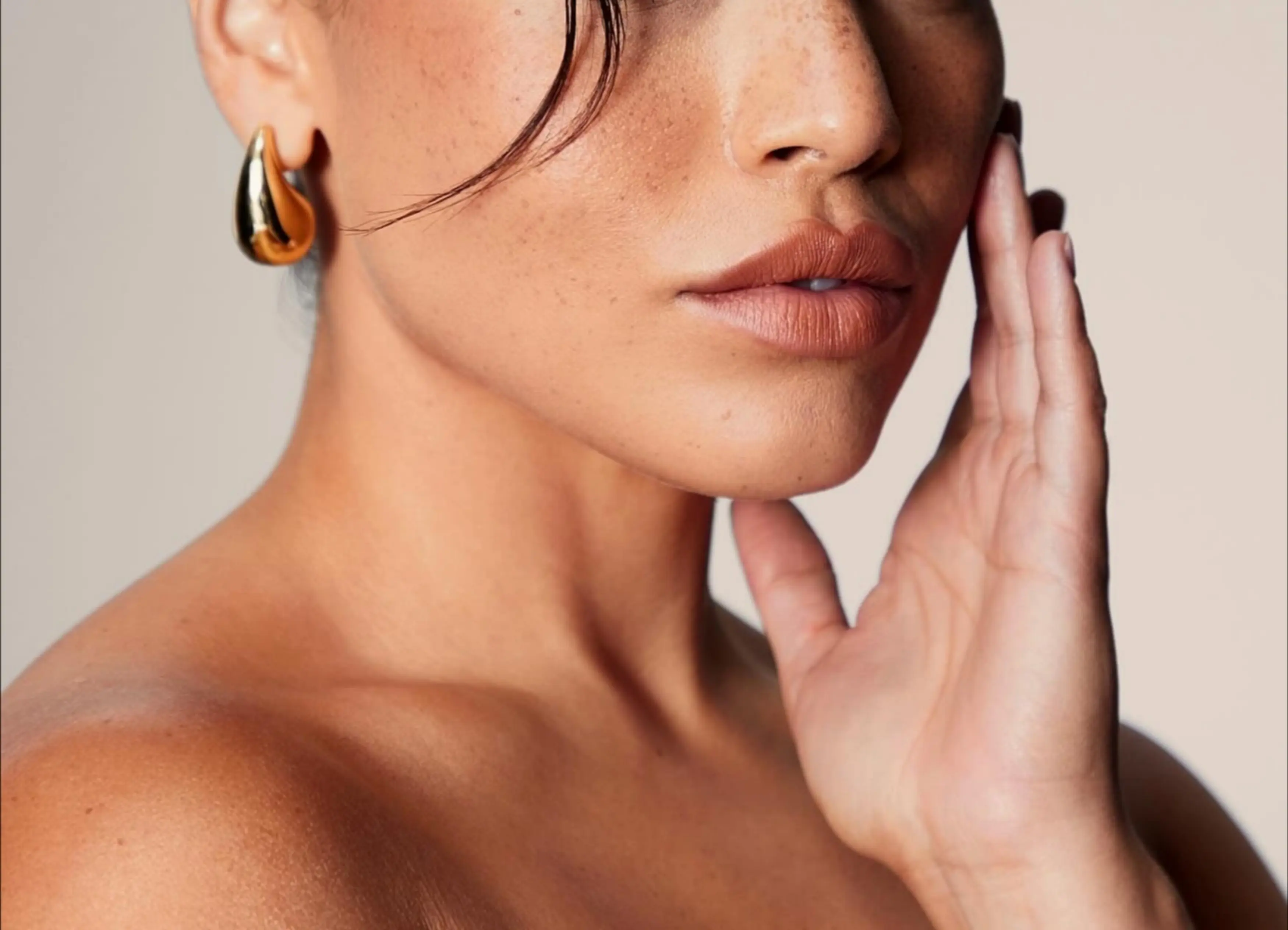 A close up of a person with a ring on her finger.