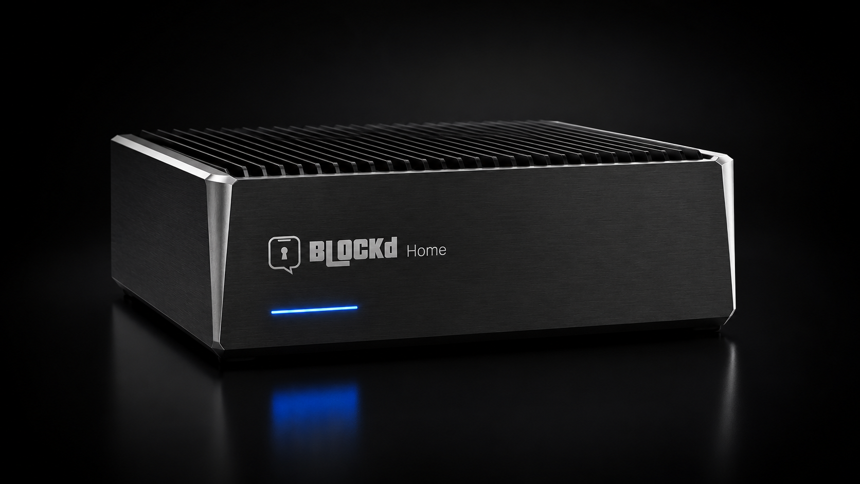 The Blockd Home Device, a premium fanless mini-PC with a blue LED indicator, photographed on a dark background