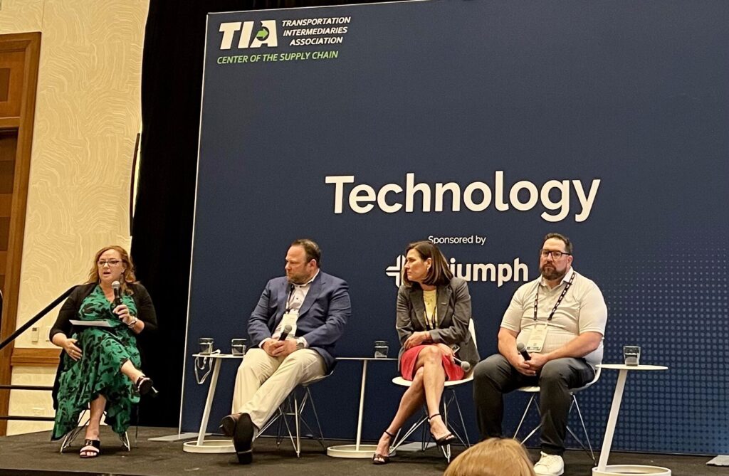 Panel discussion "You've Selected New AI Tech—Now What?" at TIA event, featuring four panelists on stage with blue background. 
