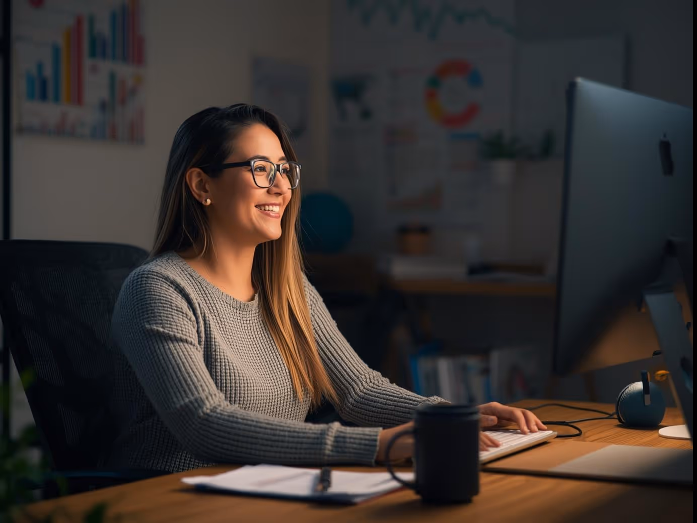 Small business owner reviewing Google Ads results on computer.