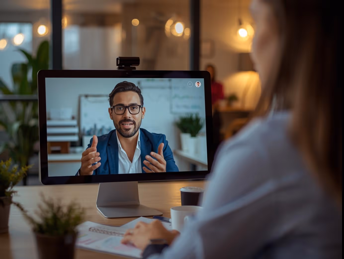 Business leader discussing project brief with copywriter on video call.