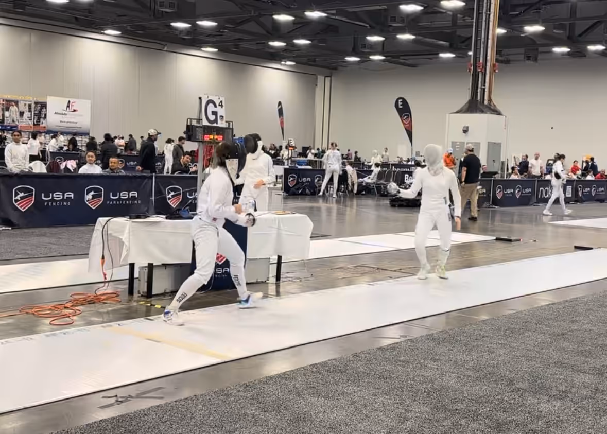 Fei L at a fencing competition.