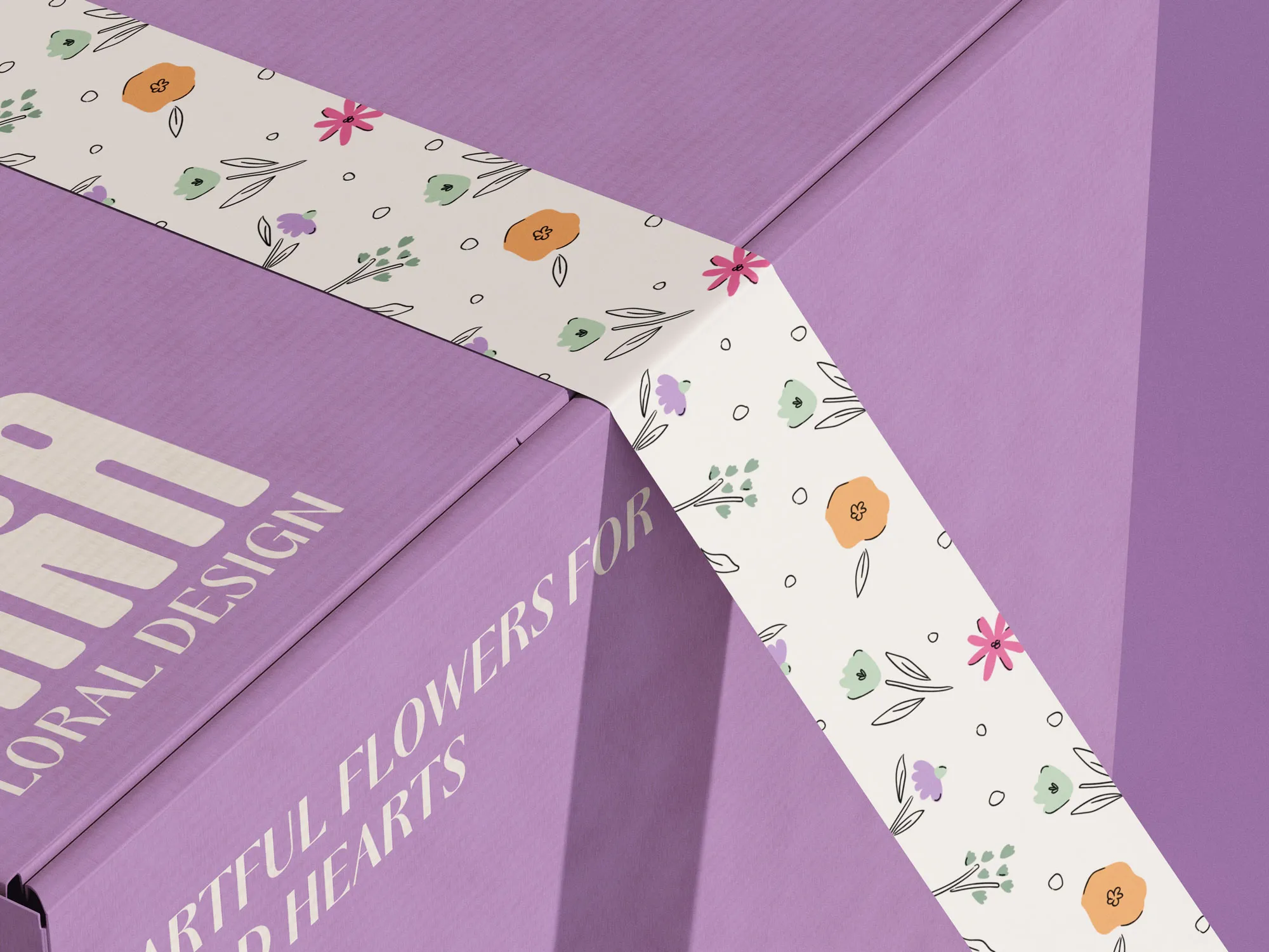Close-up of a purple floral design box with a white decorative band featuring colorful floral illustrations.