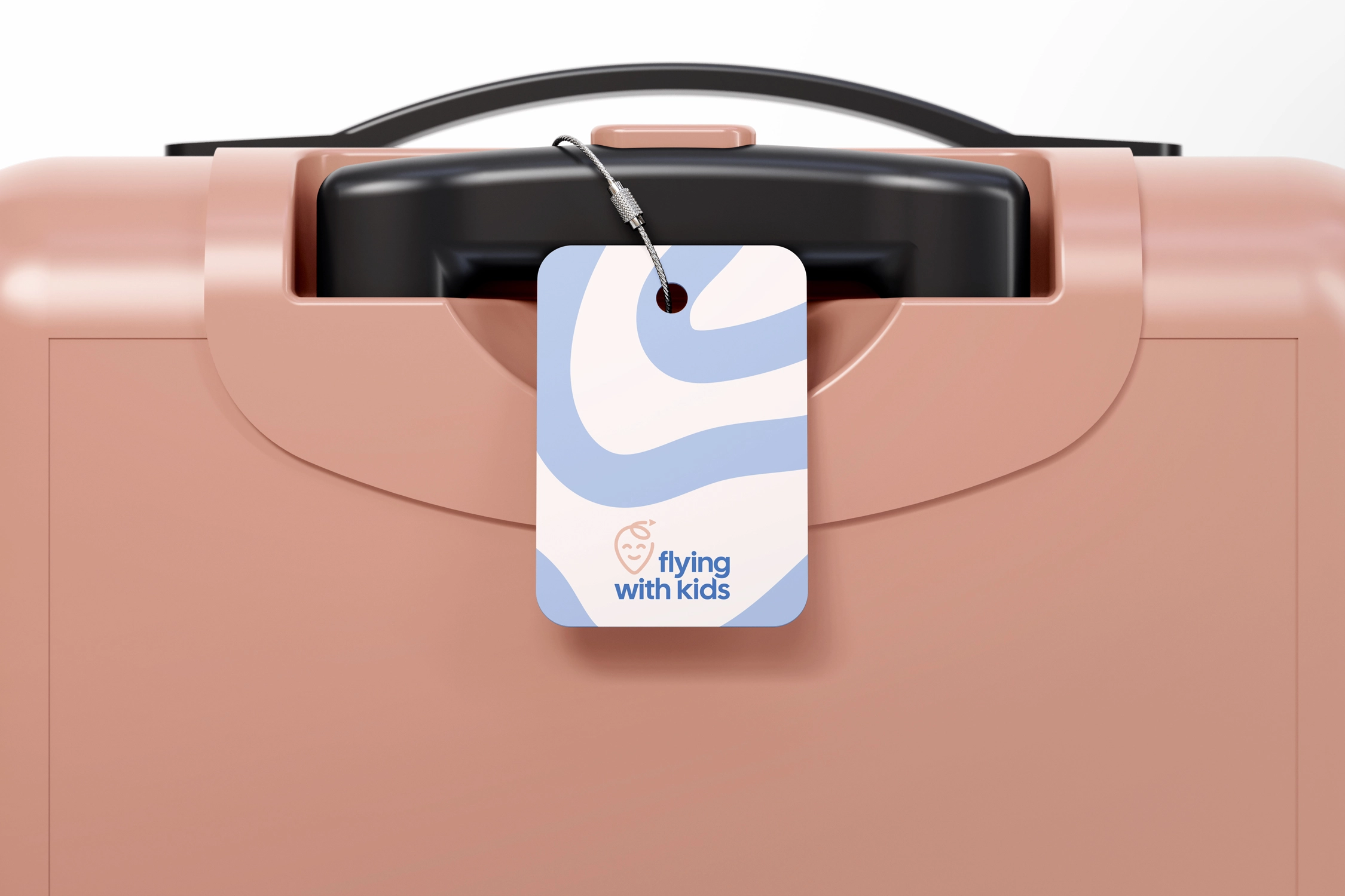 Pink suitcase with black handle and a luggage tag reading 'flying with kids' with blue abstract design.