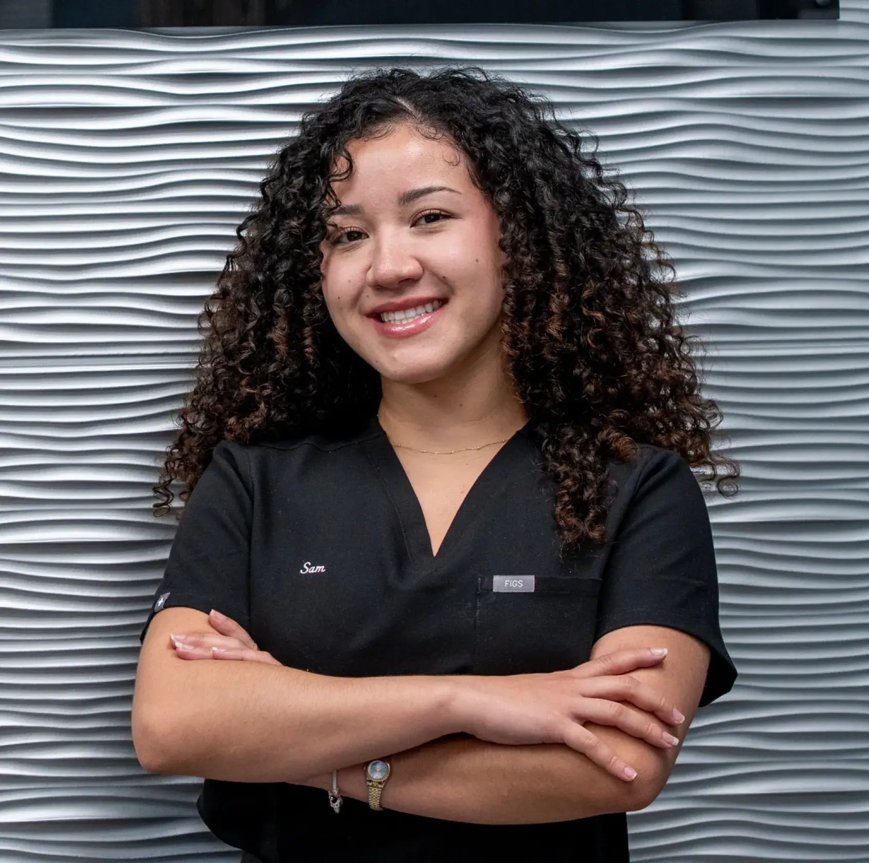 Smiling man in dental chair holds mirror, woman in dental uniform stands beside him, both look happy.