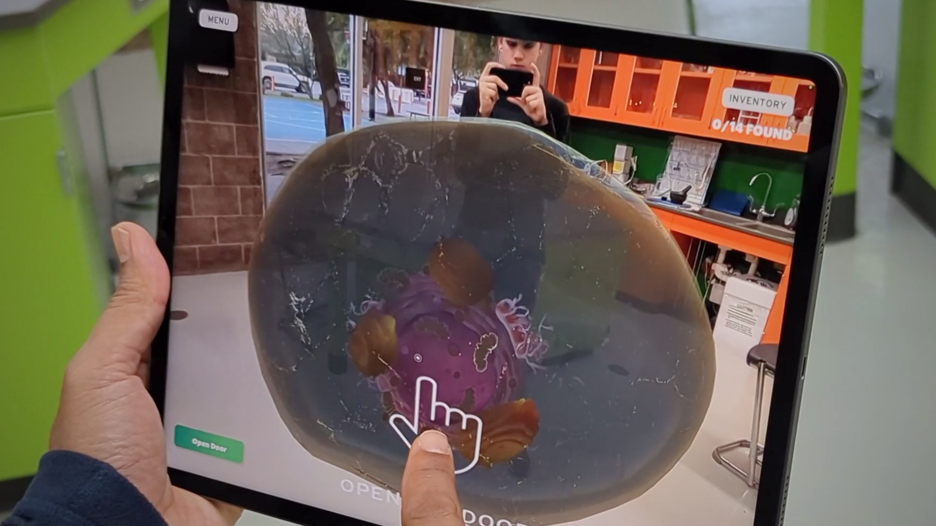 Student exploring an animal cell on an ipad.