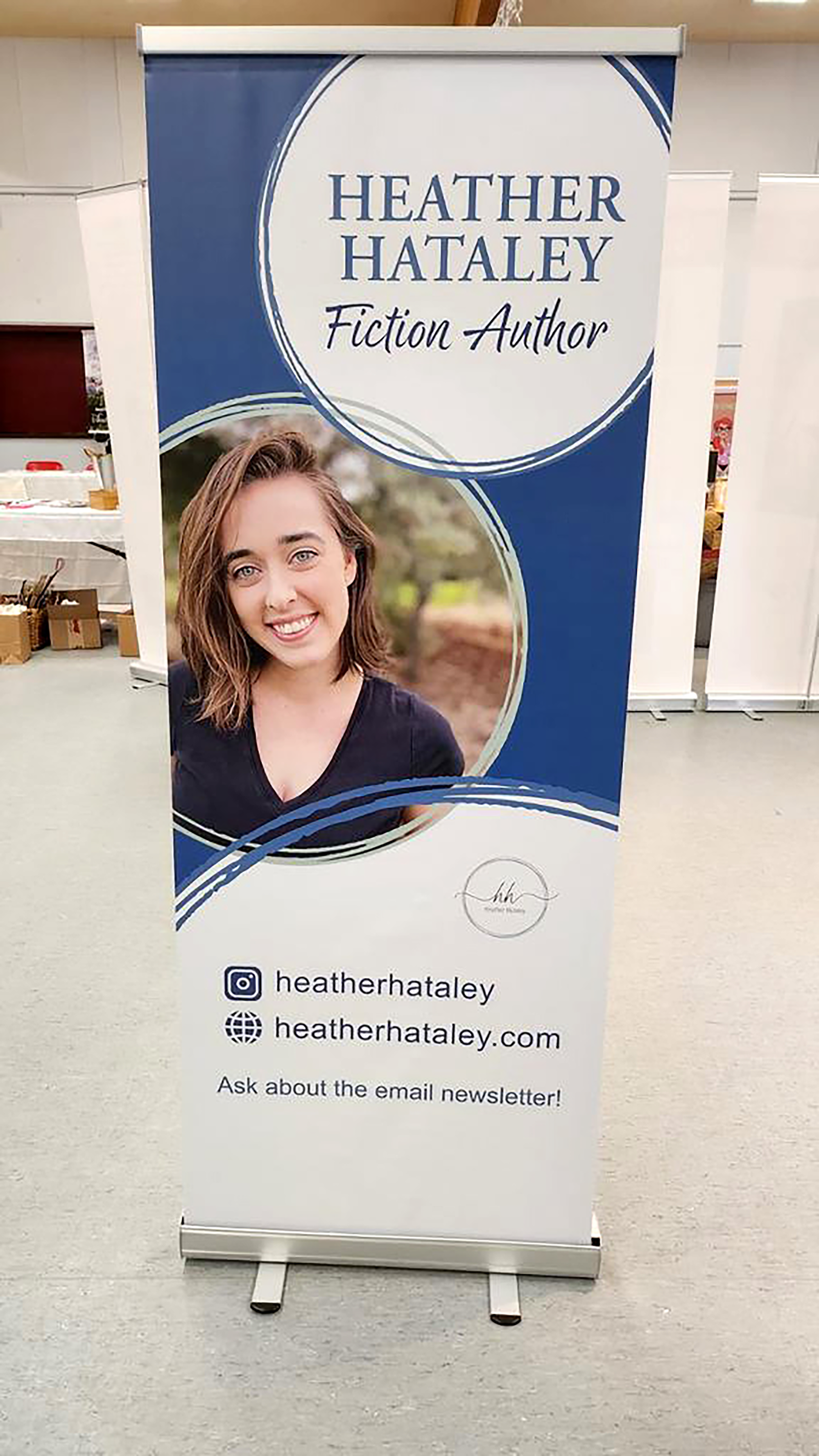 Heather Hataley standing banner at an event