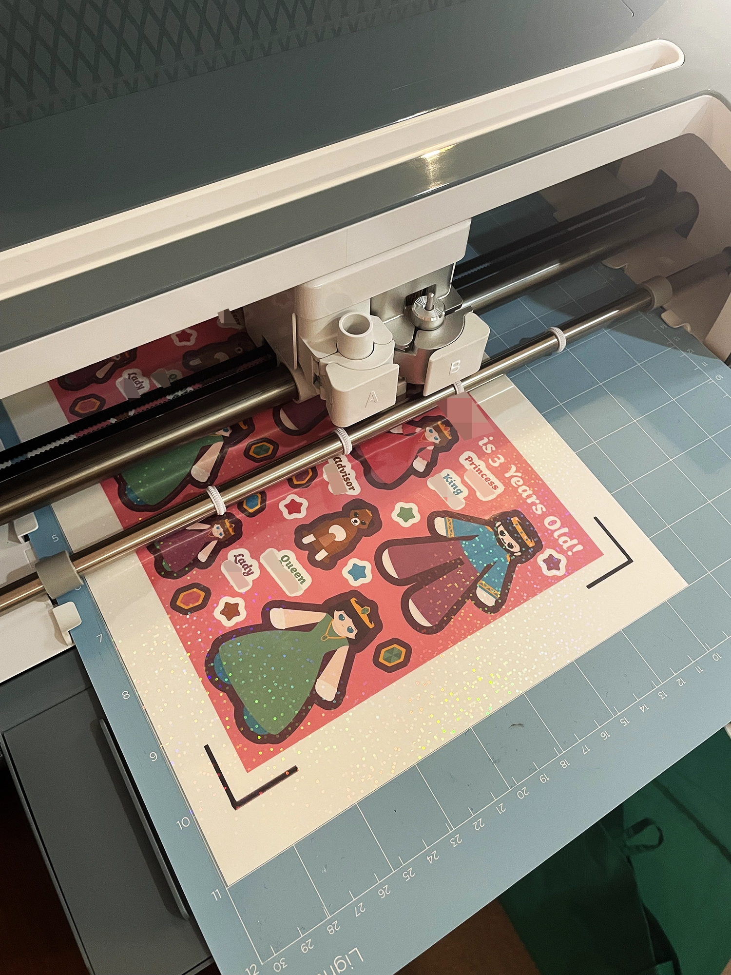 Princess themed sticker sheets being cut out on cutting machine
