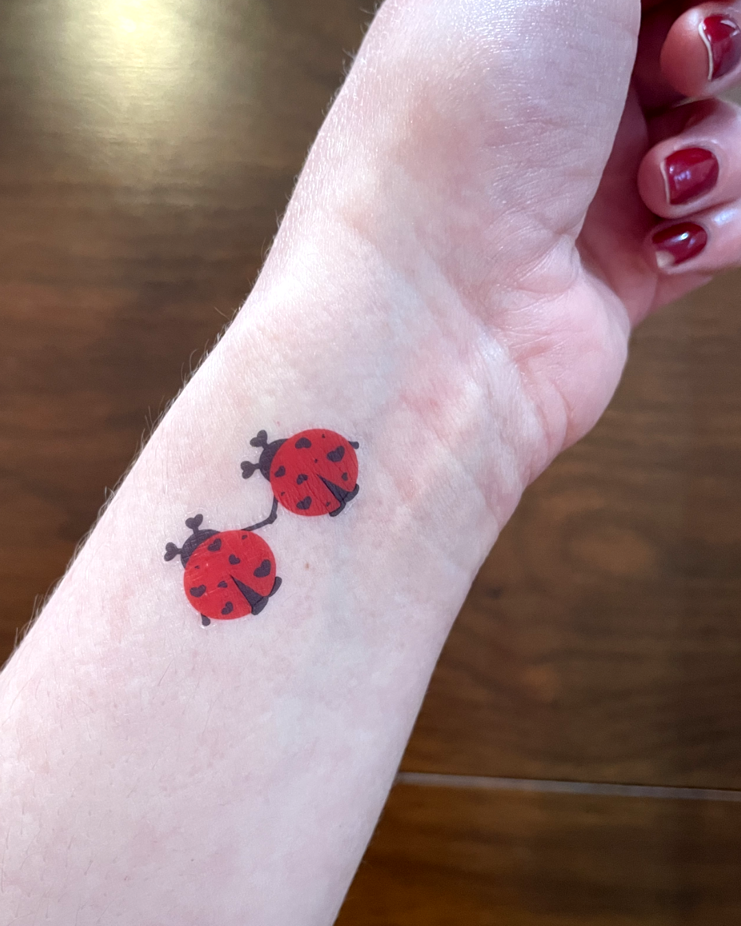 Temporary tattoo with ladybugs on arm