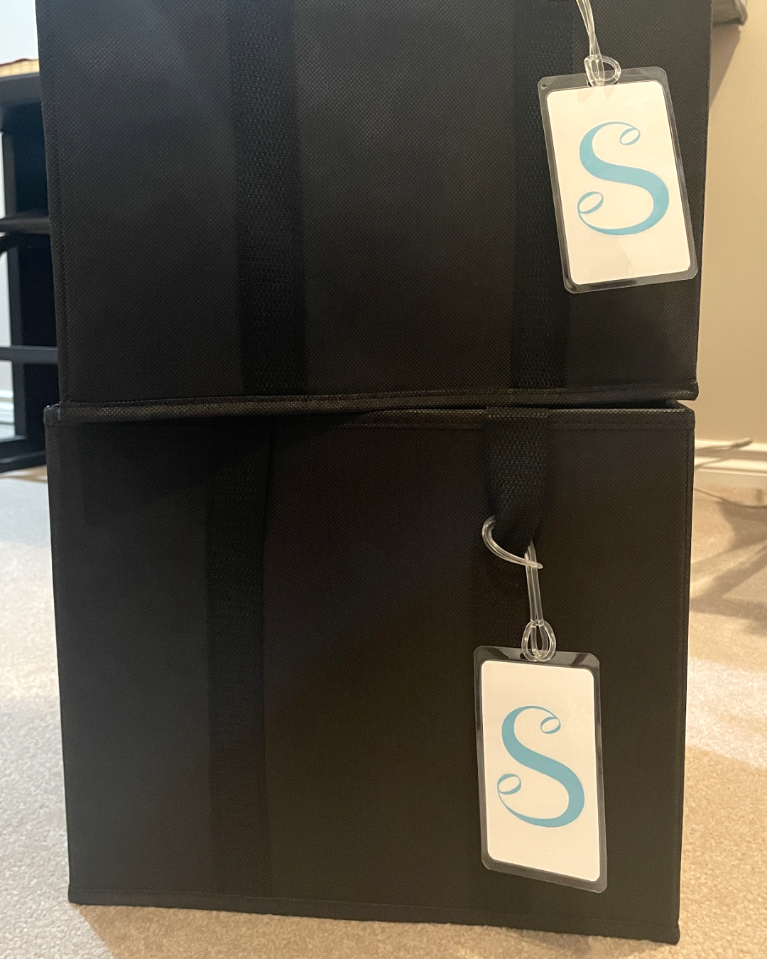 Laminate labels with the 'S' logo on black bags