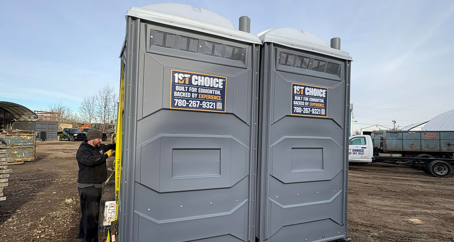 Portable Toilets being dropped off by a 1st choice employee at a construction site.